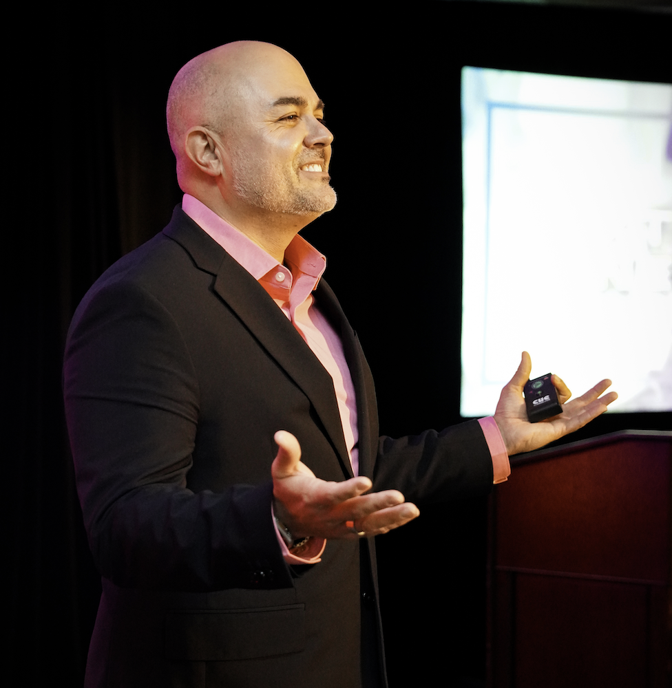 Armando Leduc speaking on stage